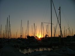 sunset over the boats on the pier in La Manga