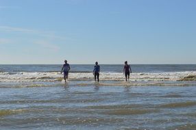 People in water waves seashore scene