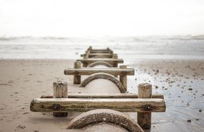 wooden fence on the beach