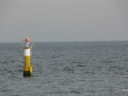 Yellow and white lighthouse in the Pacific Ocean off the coast of Costa Rica