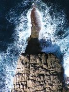 panorama of blue surf on a rocky shore