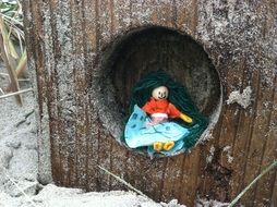 handmade doll on beach cabin