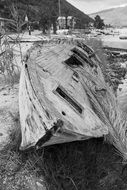 photo of an old boat on the shore