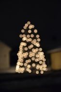 illuminated christmas tree in darkness, bokeh