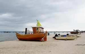 boats on the sandy shore on a cloudy day