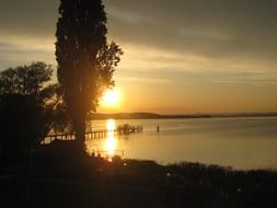 mirror reflection of the sun on lake constance