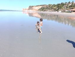 children play on beach