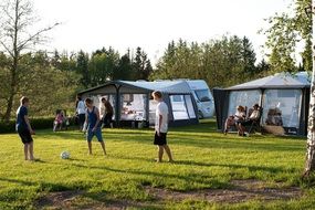 teens play football on a camping trip