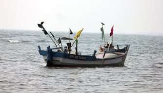 fishing boat with flags in the ocean