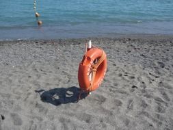 life saving ring, buoy, on sea beach