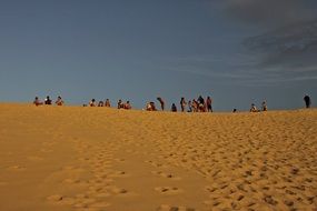 people on the sand dune