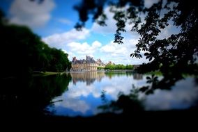 distant view of a palace near a lake in france