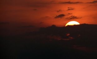 red sun behind the mountain