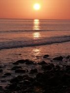 reflection of the setting sun in the sea