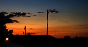 Electric poles on the sunset background