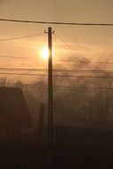 power lines and chimney in the fog