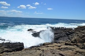 the waves beat on the rocks on the beach