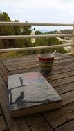 Book and coffee on a wooden table