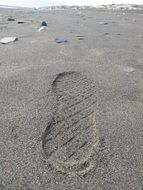 big shoe footprint on sand