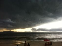 black rain clouds over the beach