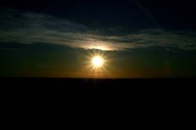 bright shining sun in the dark sky
