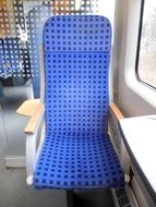 blue seat by the window in the train