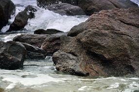 sea waves splashing on stones