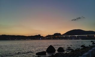 sunset glow in sky above sea coast