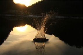 spray on the lake at sunset