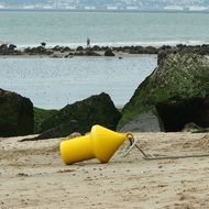 yellow buoy on the beach in Normandy