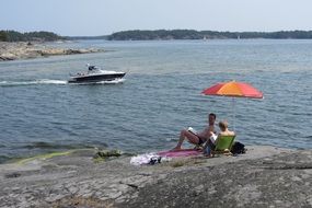 Couple resting on a shore