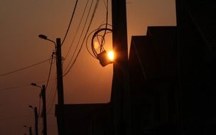 orange sunset over the pillars with wires