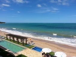 resort with pool on the beach near the sea