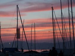 landscape of sailing boats in port at dusk