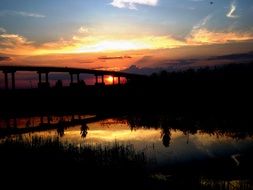 sunset in the evening bridge water reflection