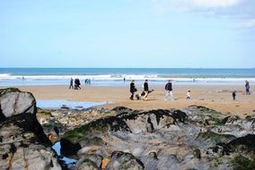 people on the beach at low tide
