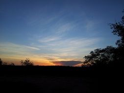 picturesque sunset over dark landscape