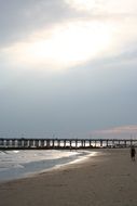 distant view of the pier on a sandy beach