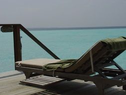 green towel on a lounger on the Indian Ocean, maldives