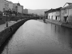 black and white photo of water canal in otaru