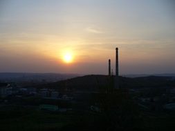 Beautiful and colorful sunset above the beautiful landscape with silhouettes