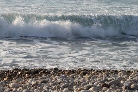 stones on a beach and waves on atlantic ocean