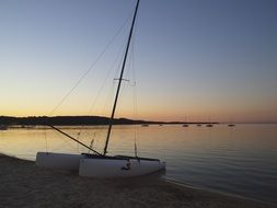 sailing boat on beach at dusk, france