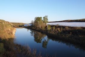 quiet spring river in green foliage