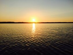 mirror image of a golden sunset over the lake