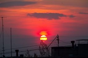 Roofs of houses with antennas at sunset