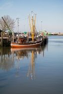 fishing boat reflected in the water
