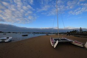 sailing boats on the beach in the evening