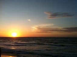 the sun sets over the horizon