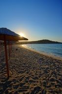 sun over the beach on milos